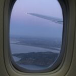 airplane window showing ireland's coast