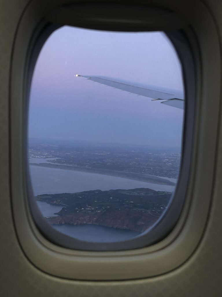 airplane window showing ireland's coast